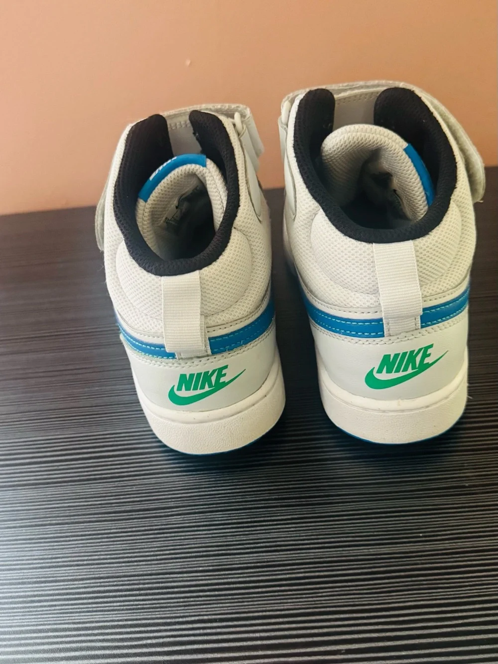 Nike White High-Top Sneakers with Blue Swoosh Accents